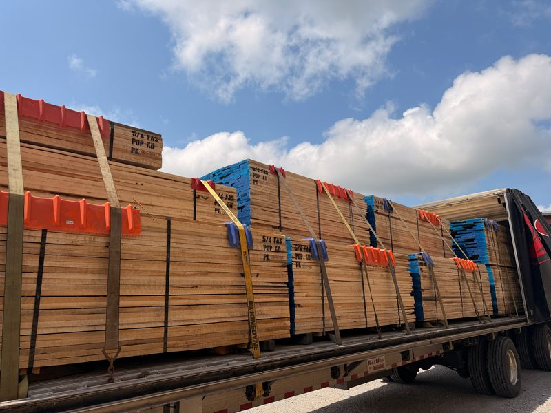 Lumber bundles strapped on a Fission flatbed with edge protectors