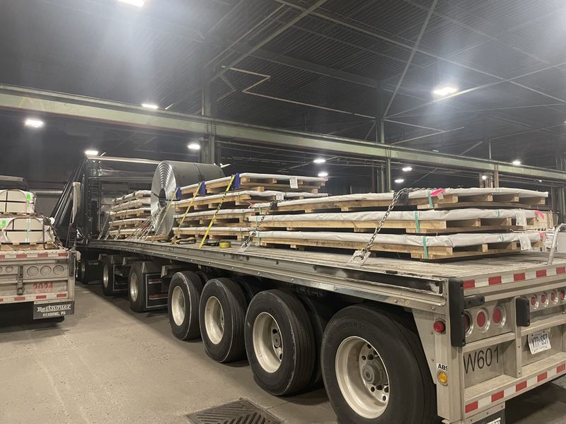 Steel plate on skids strapped on a Fission multi axle flatbed